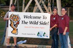 Lykens Tigers President celebrating the new announcers' booth for their field before some Pine Creek representatives served up an ice cream party for the kids.